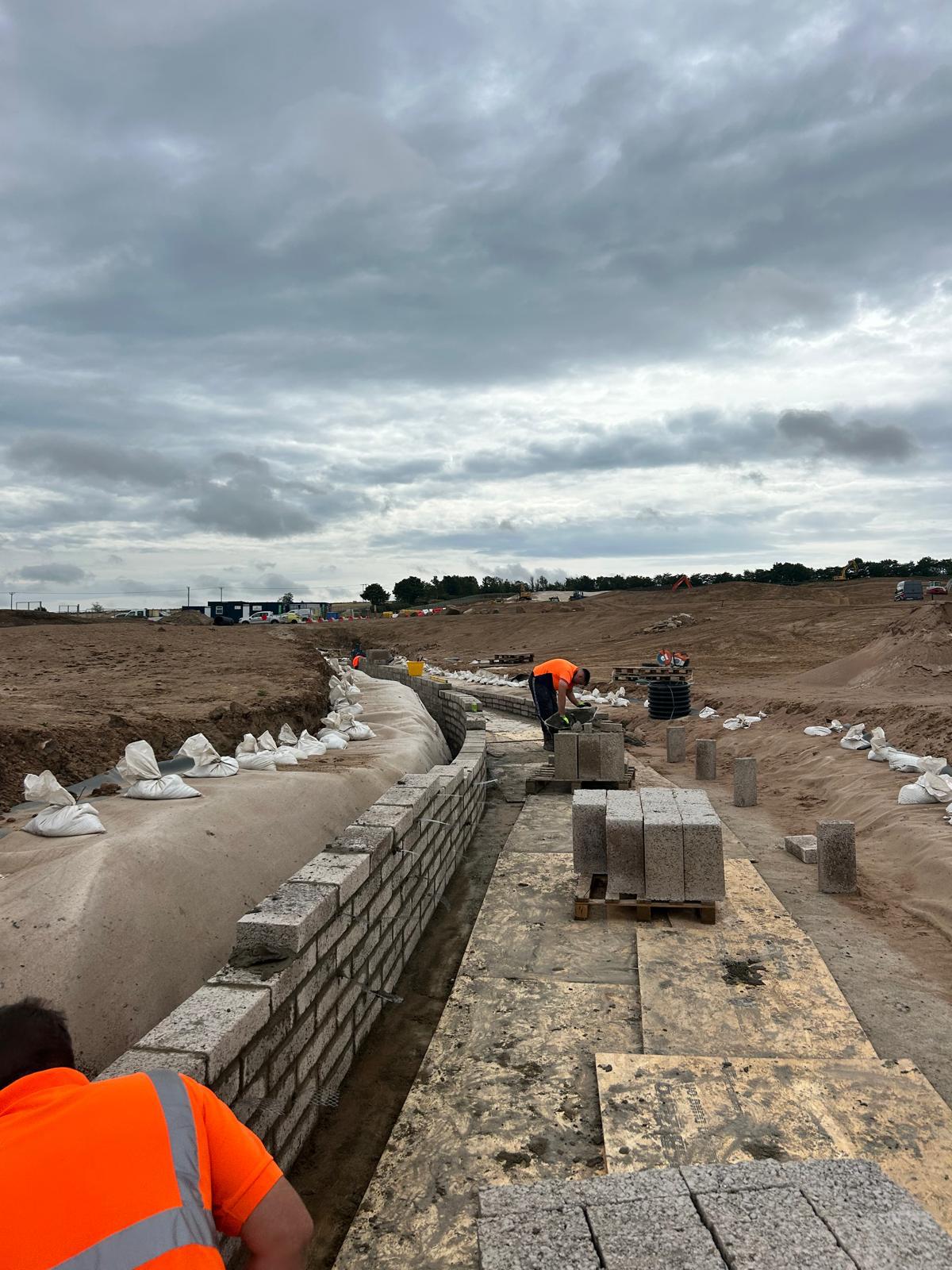 Block retaining wall under construction on development site