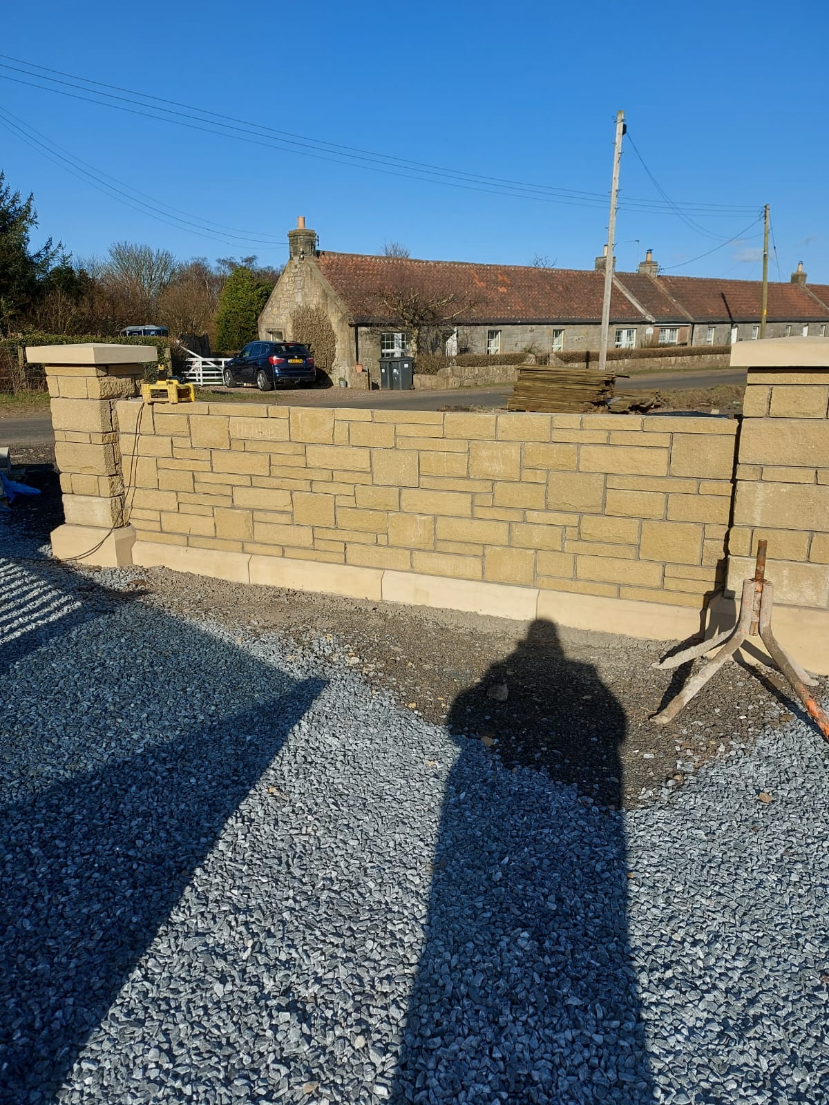 Recently completed natural stone boundary wall with neat coursing and capping, Perthshire